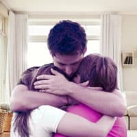  Father enbracing two children.