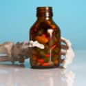  A skeleton holding a pill bottle.