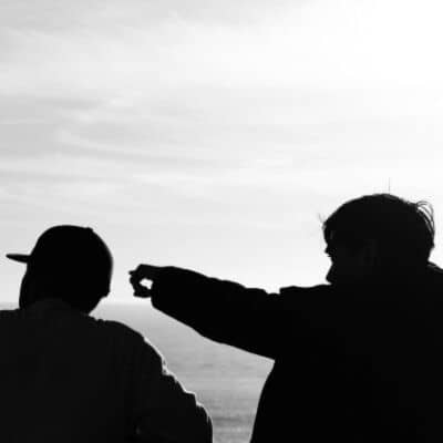  A person pointing out different things to another.