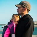  A father with a daughter in his arms.