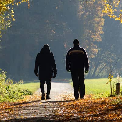  Two men walking in a park.