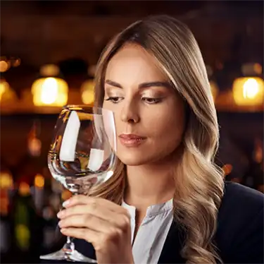 Alcohol rehab in Alberta, am I addicted a woman looking at a glass of wine.