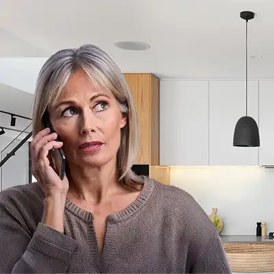 Woman on phone speaking to a drug rehab counsellor.