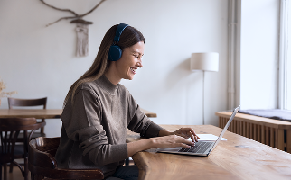 A woman looking at a laptop smiling